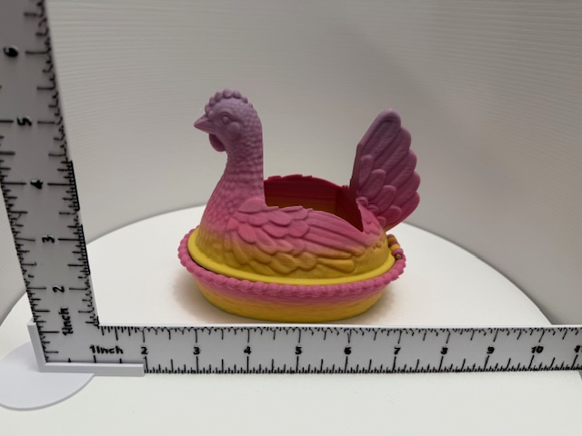 Pink and yellow gradient hen trinket box closed, side view with ruler for scale