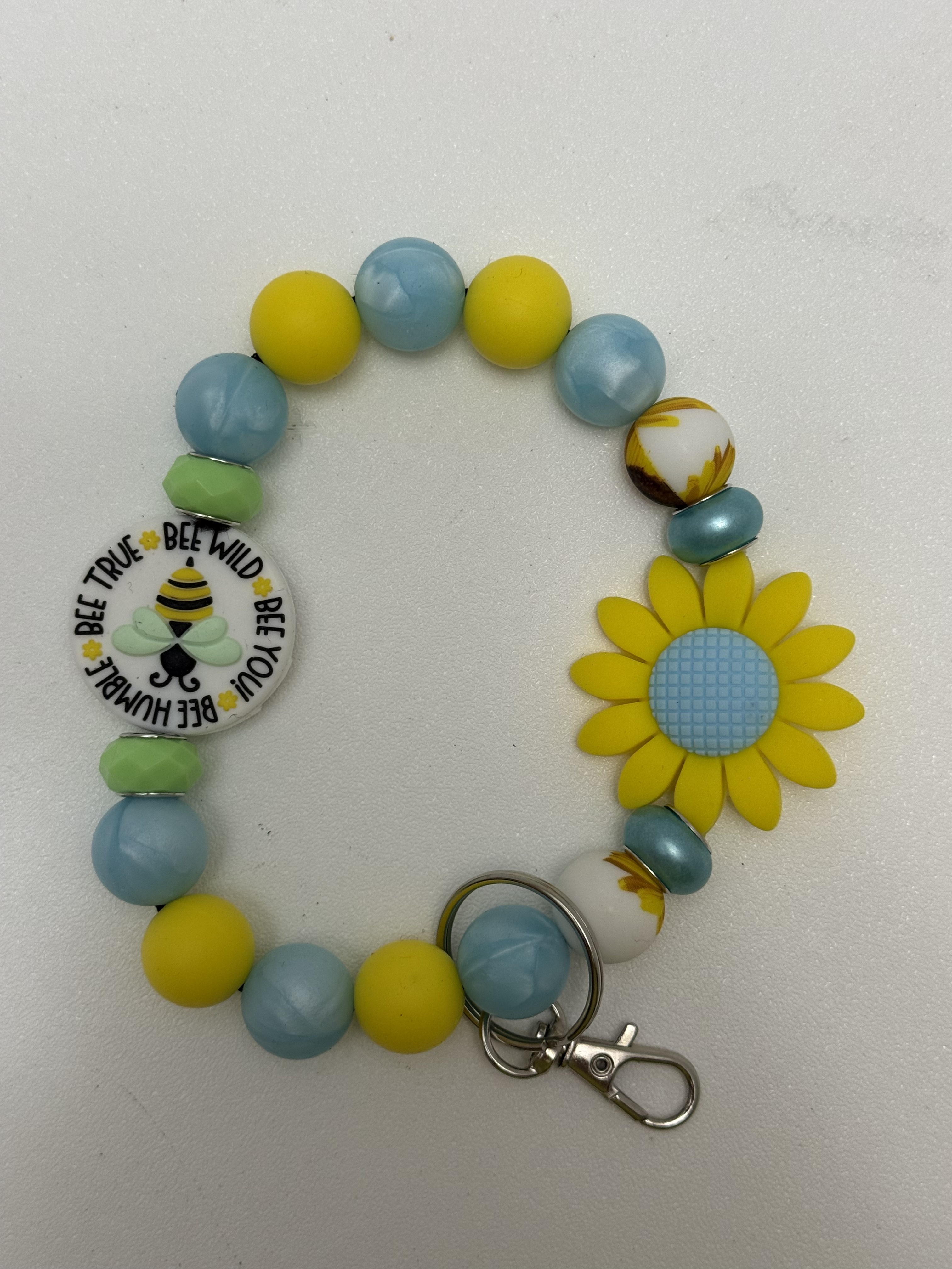 Yellow and sky-blue beaded wristlet keychain with sunflower focal bead and bee mantra charm
