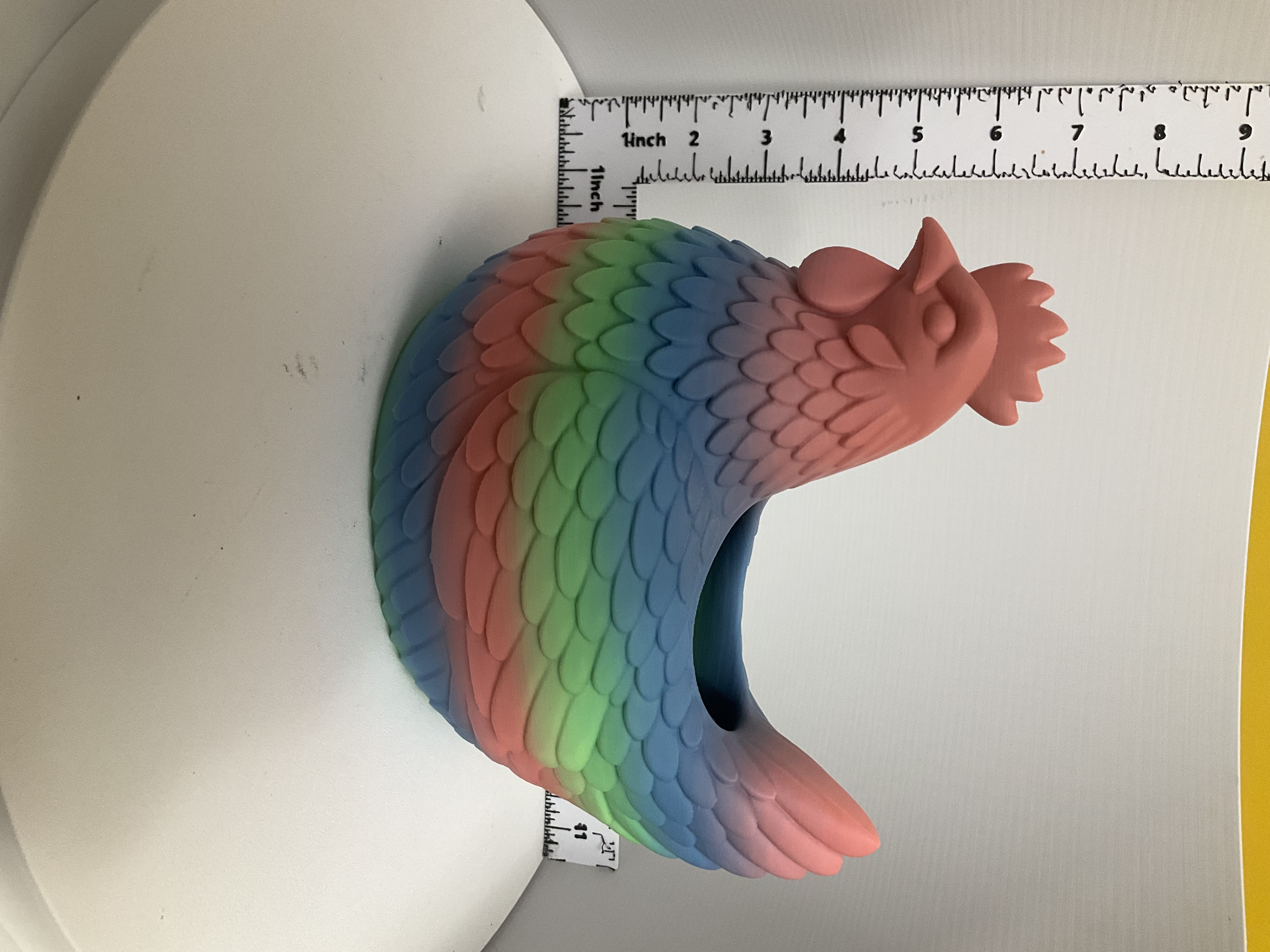 Side view of rainbow gradient hen planter with open back cavity and detailed feather texture