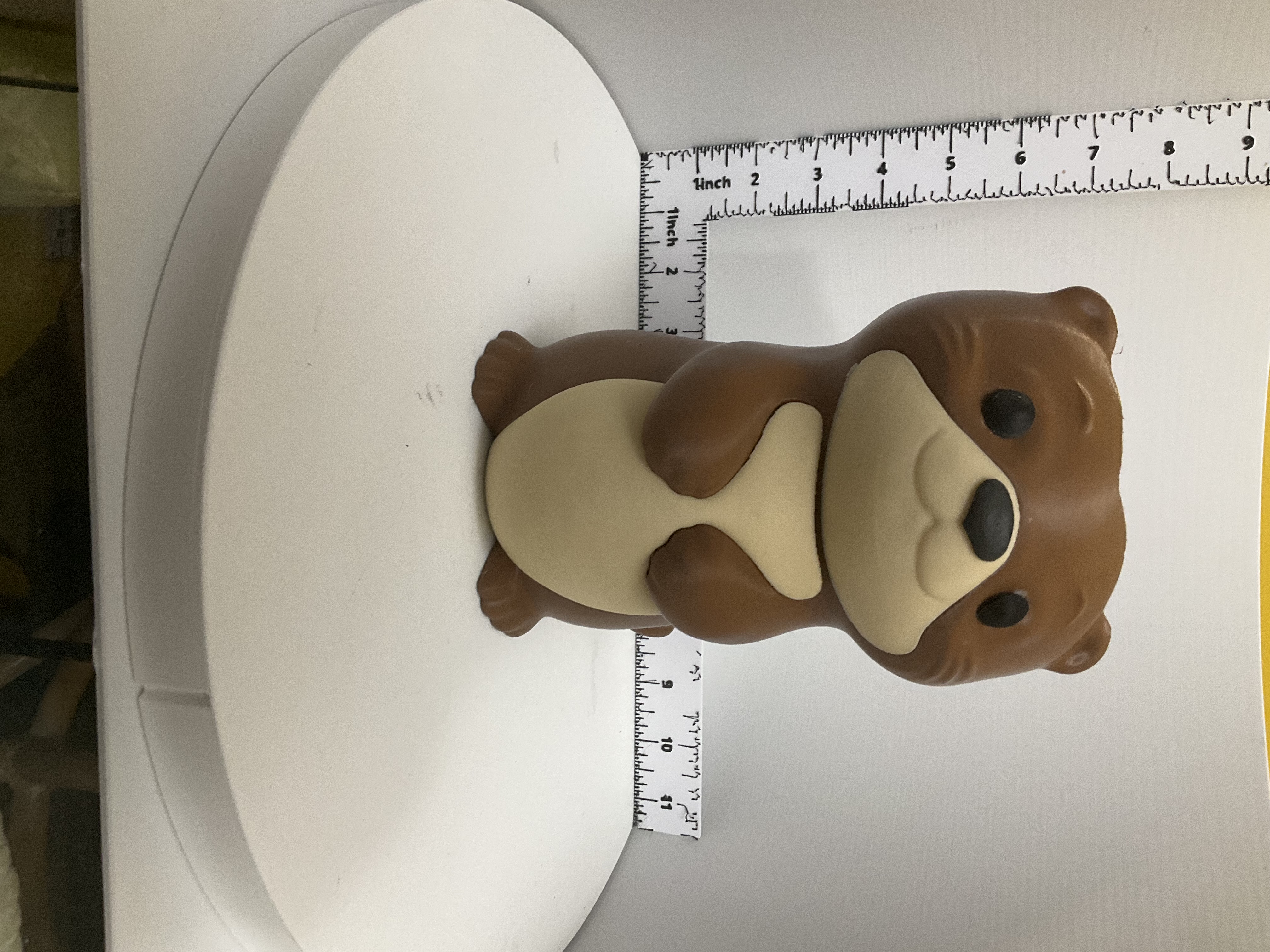 Front view of a smiling two-tone otter soap holder with cream belly and dark eyes