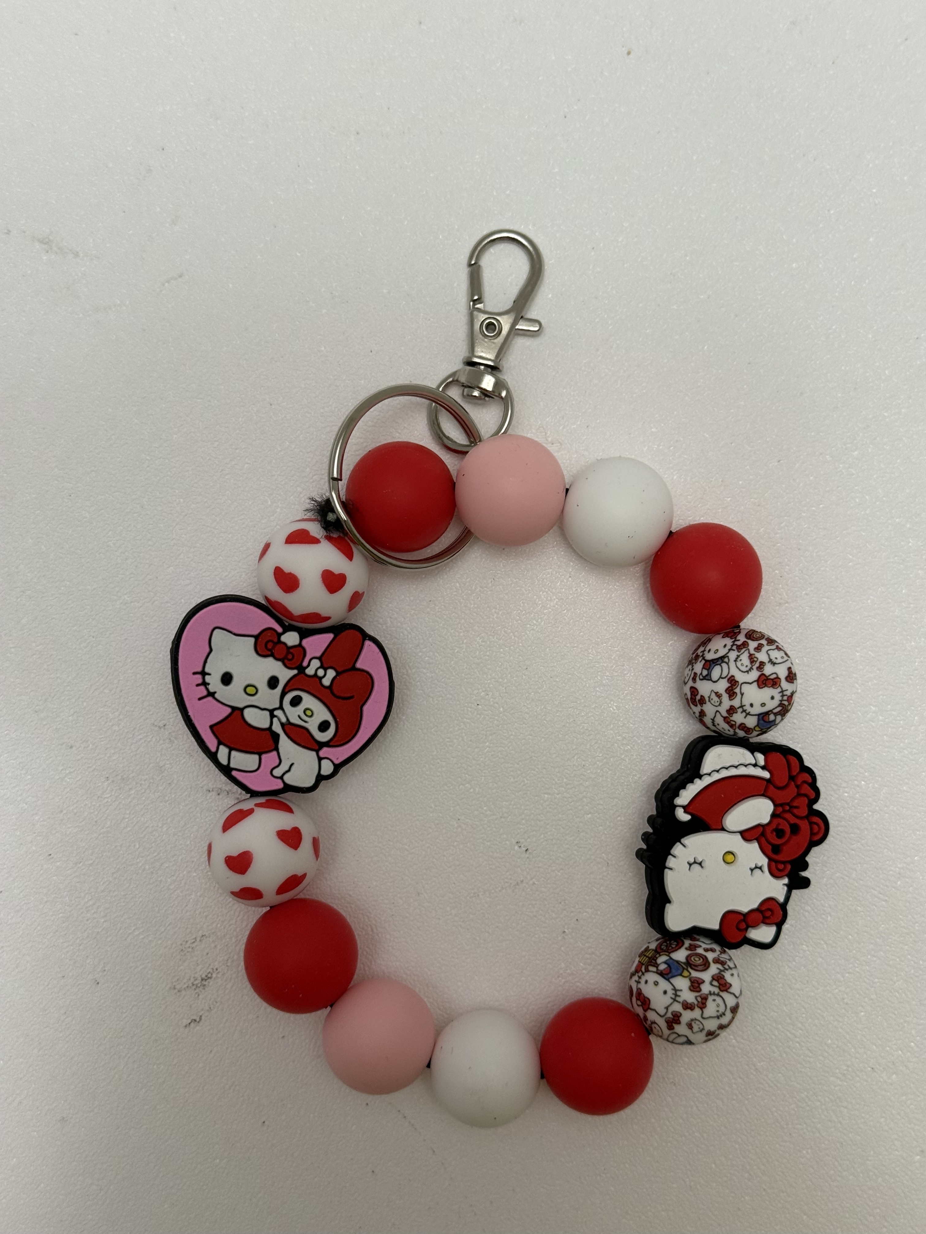 Beaded loop keychain with red pink white beads and kawaii cat charms on silver clasp