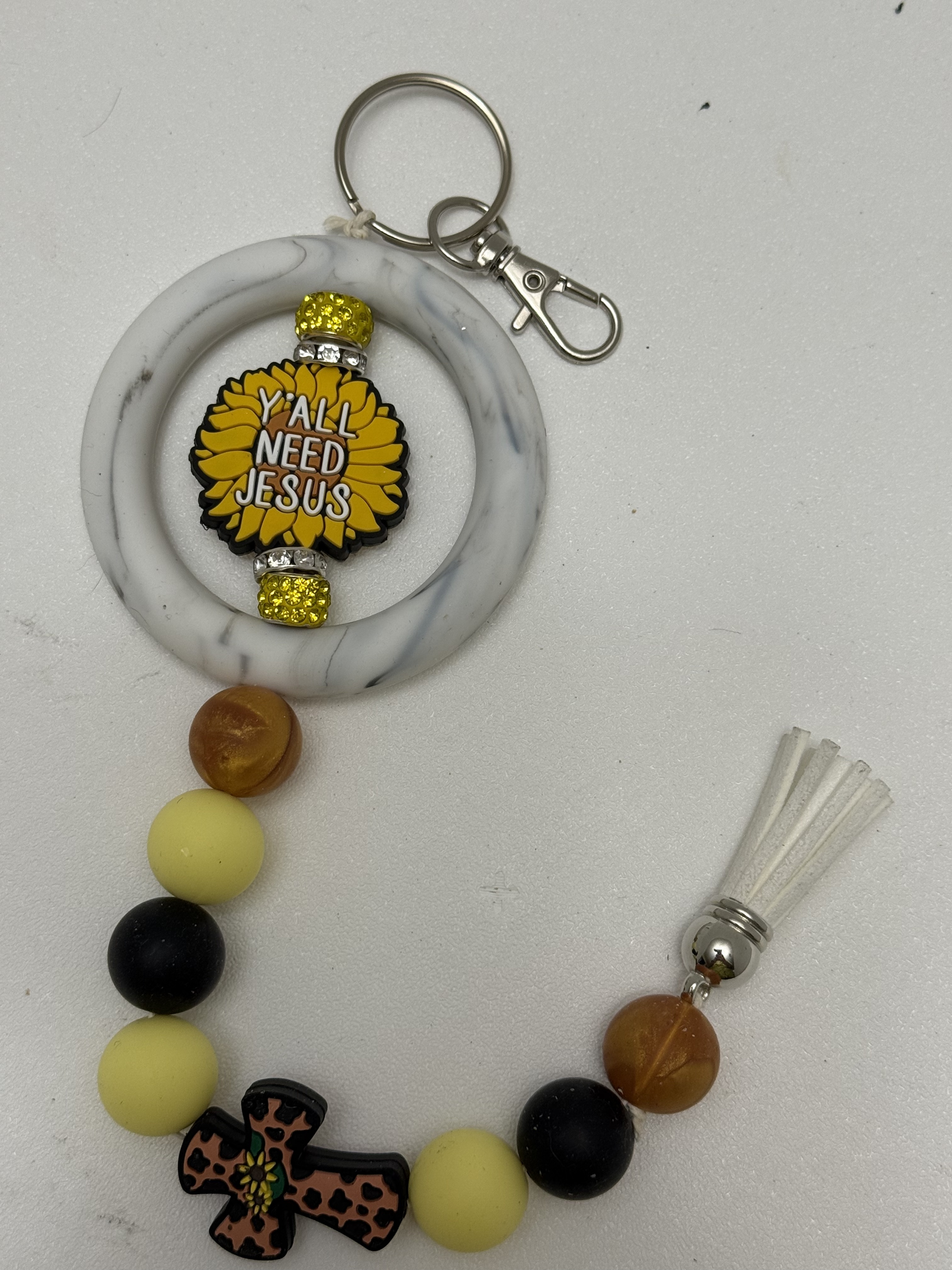 Beaded wristlet keychain with sunflower Jesus focal bead, leopard cross charm, and white tassel