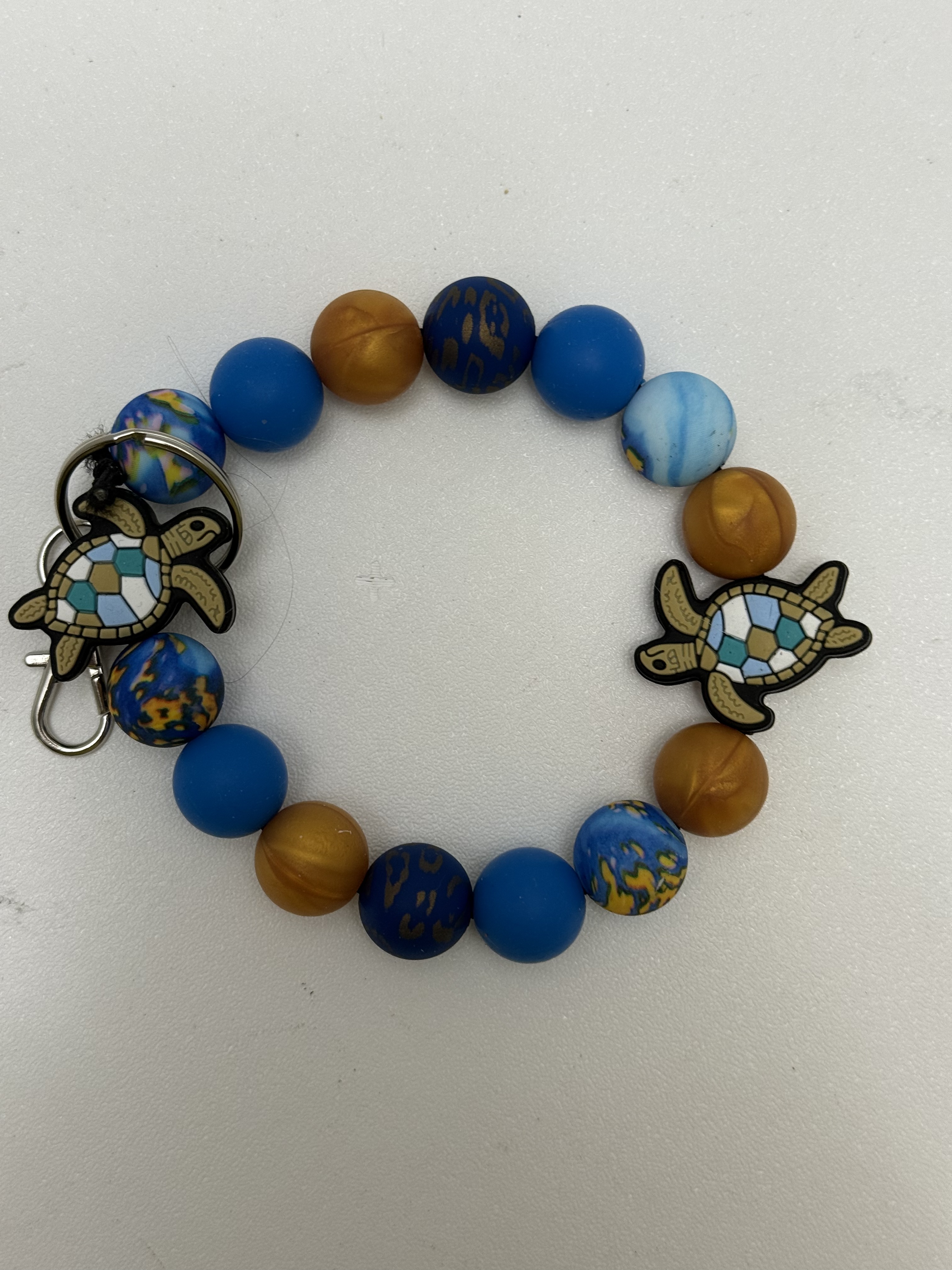 Blue and amber beaded wristlet key ring with two mosaic sea turtle charms and silver clasp