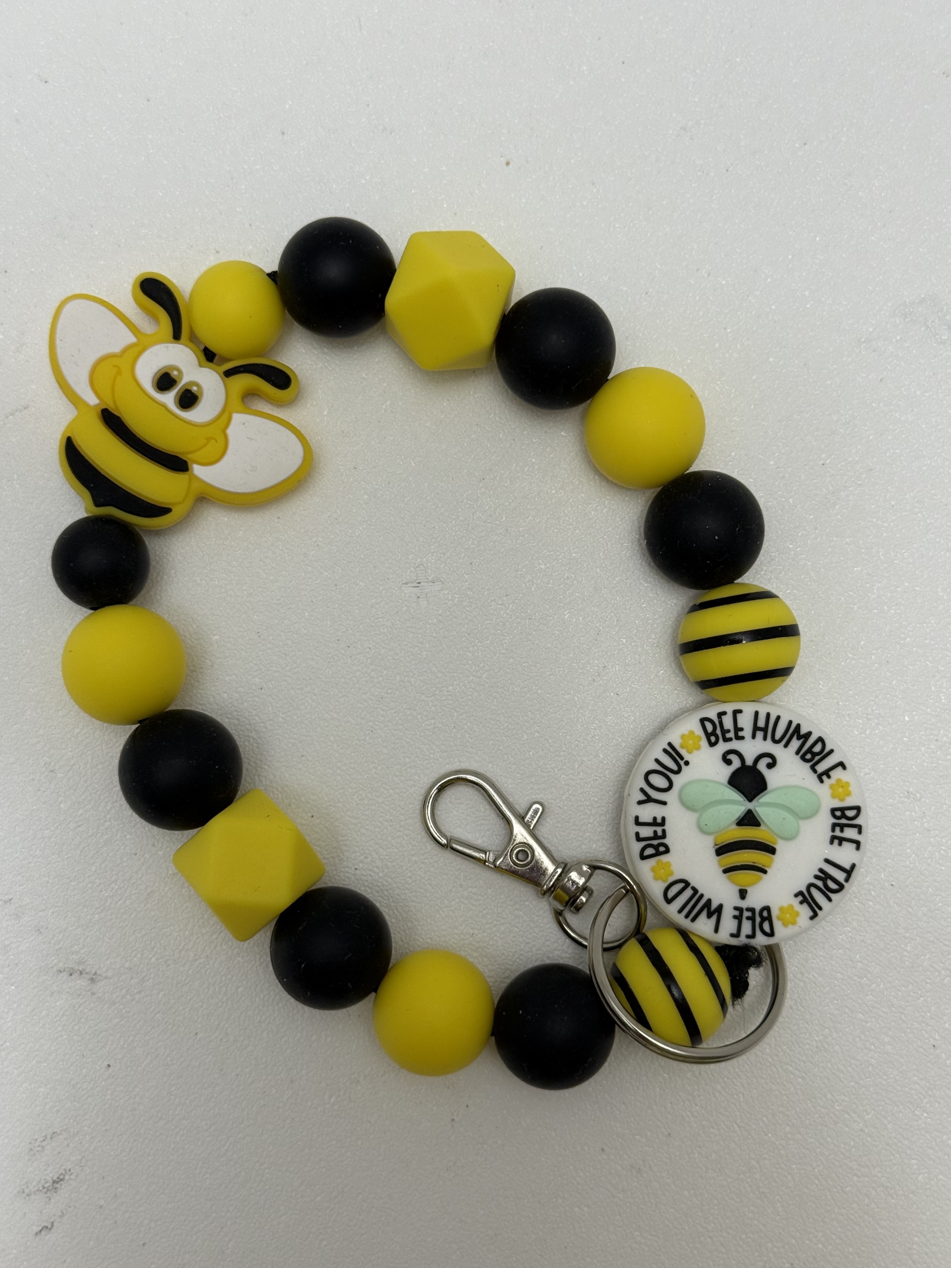 Yellow and black beaded wristlet keychain with smiling bee charm and inspirational bee disc pendant