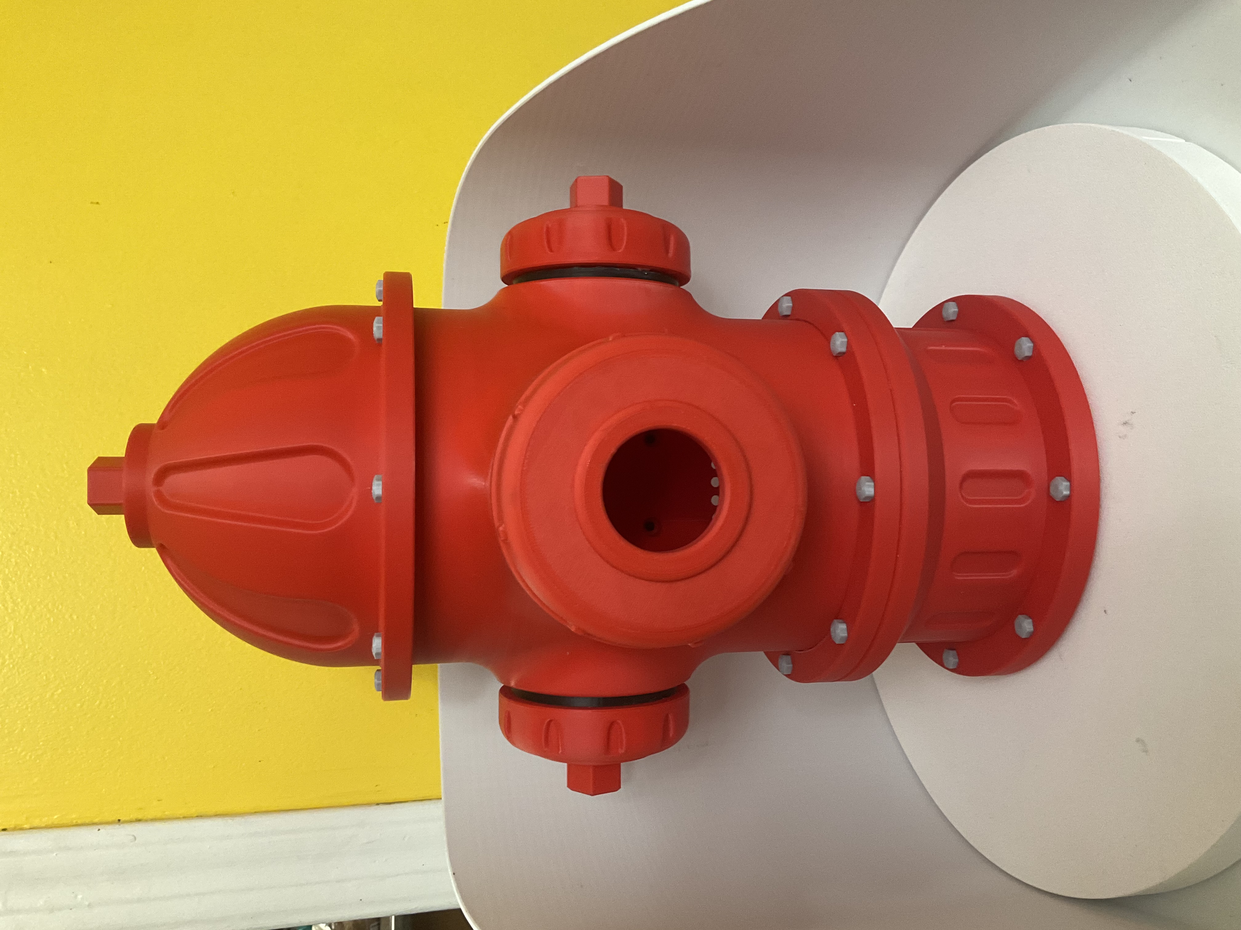 Bold red fire hydrant birdhouse with round entry hole and silver bolt accents