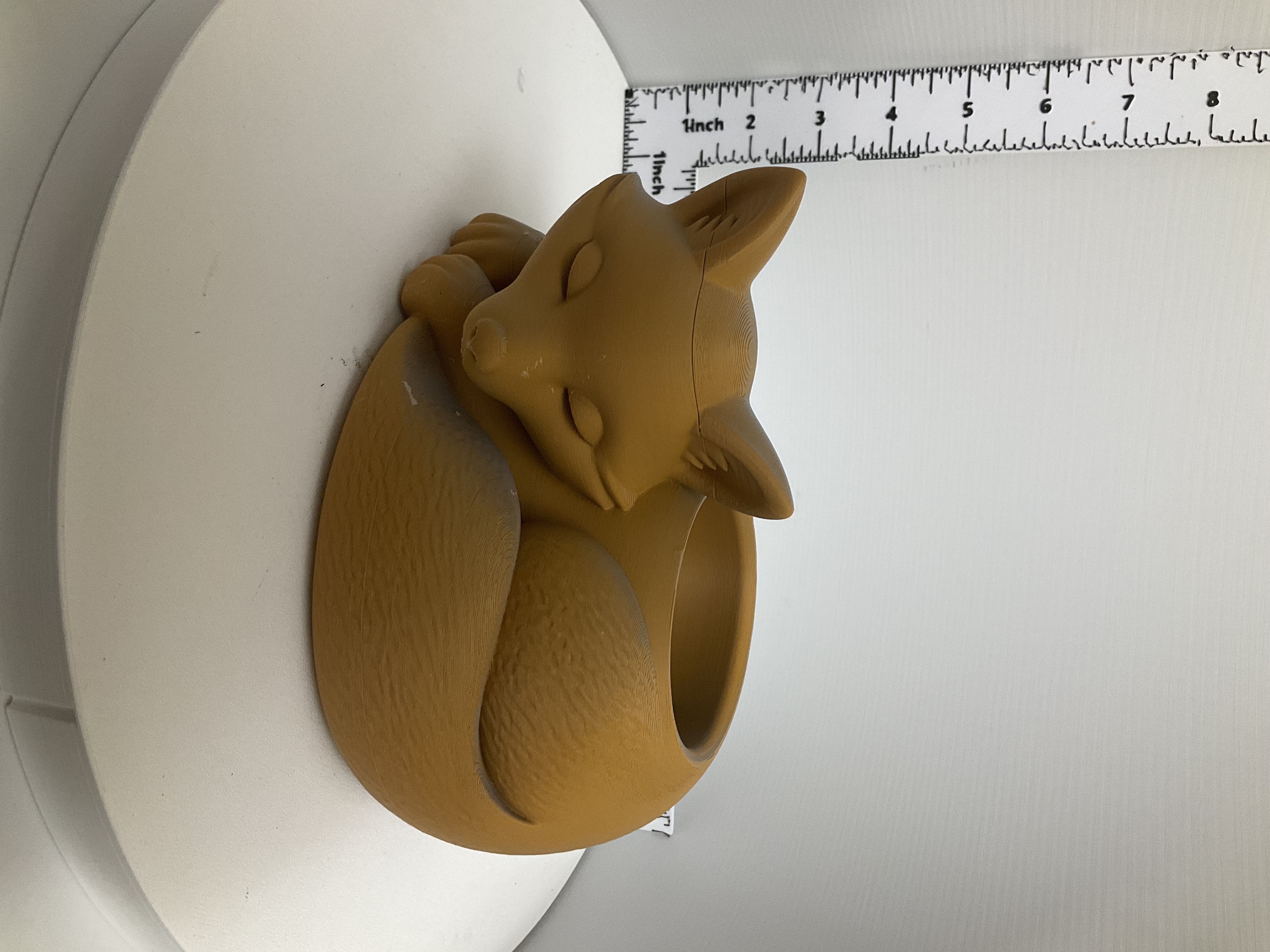 Amber-toned 3D printed sleeping fox planter with open round bowl and textured fur detail
