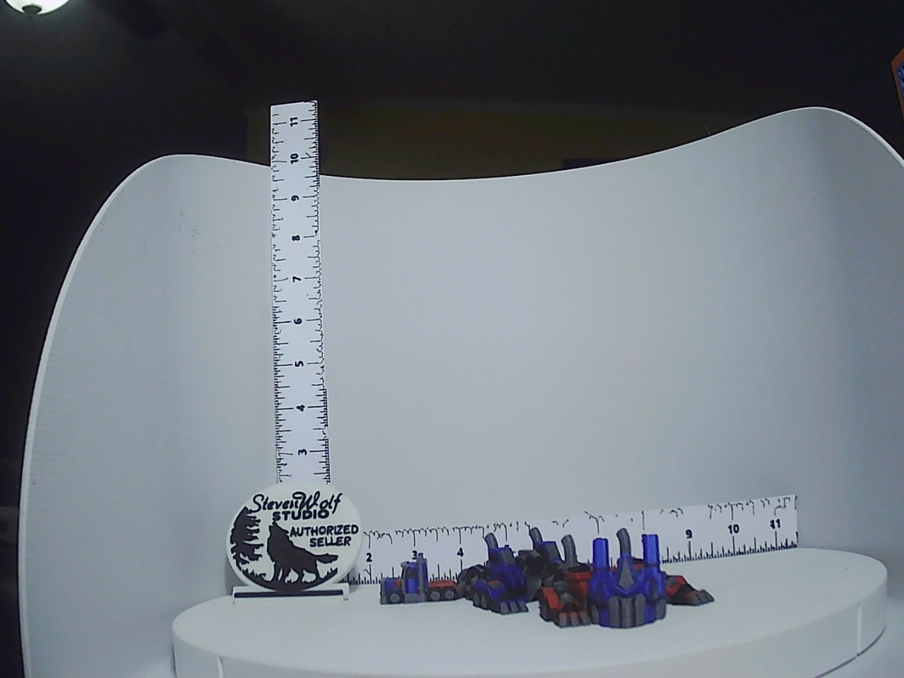 Top-angled view of small 3D-printed truck fleet showing blue red and grey color details