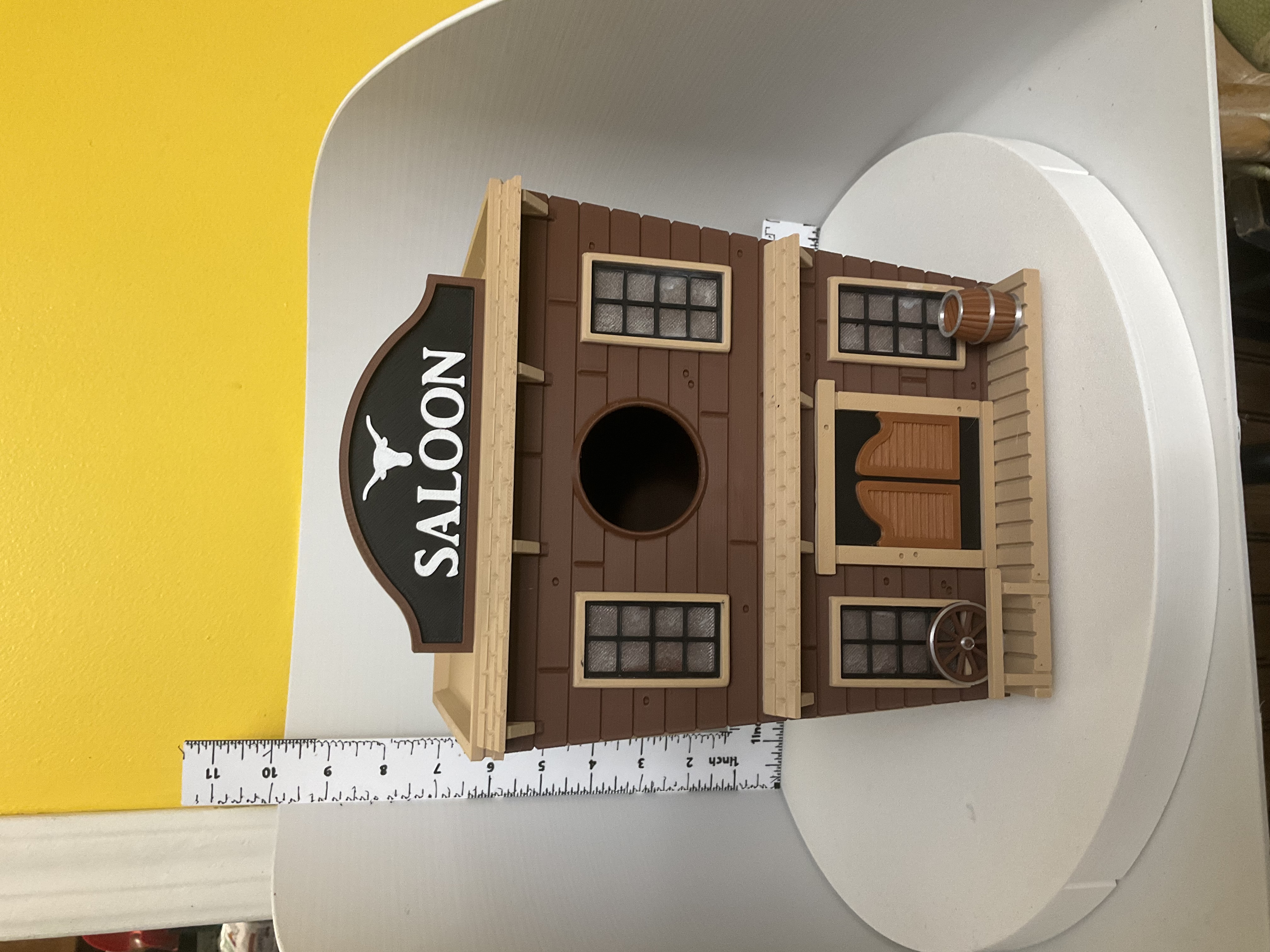 Front view of two-story saloon birdhouse with longhorn marquee sign and swinging doors