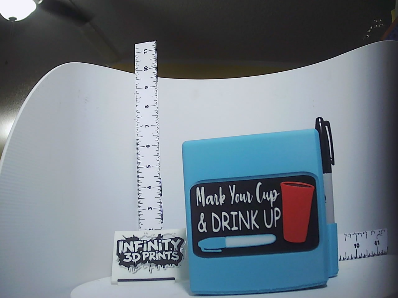 Sky-blue 3D printed marker caddy with chalkboard-style Mark Your Cup and Drink Up plaque and side pen slot