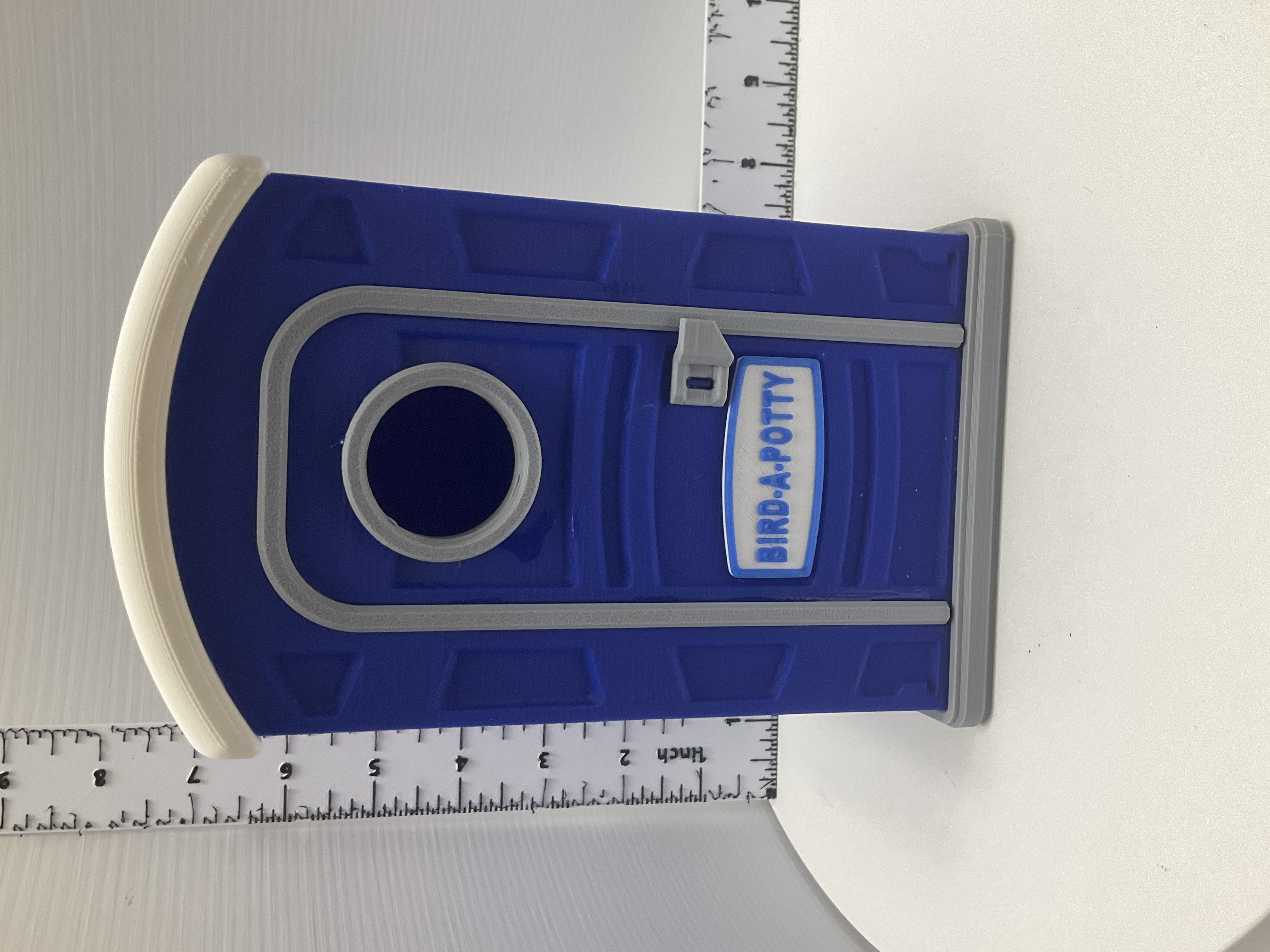 Blue 3D printed porta-potty birdhouse with gray trim and Bird-A-Potty sign on door