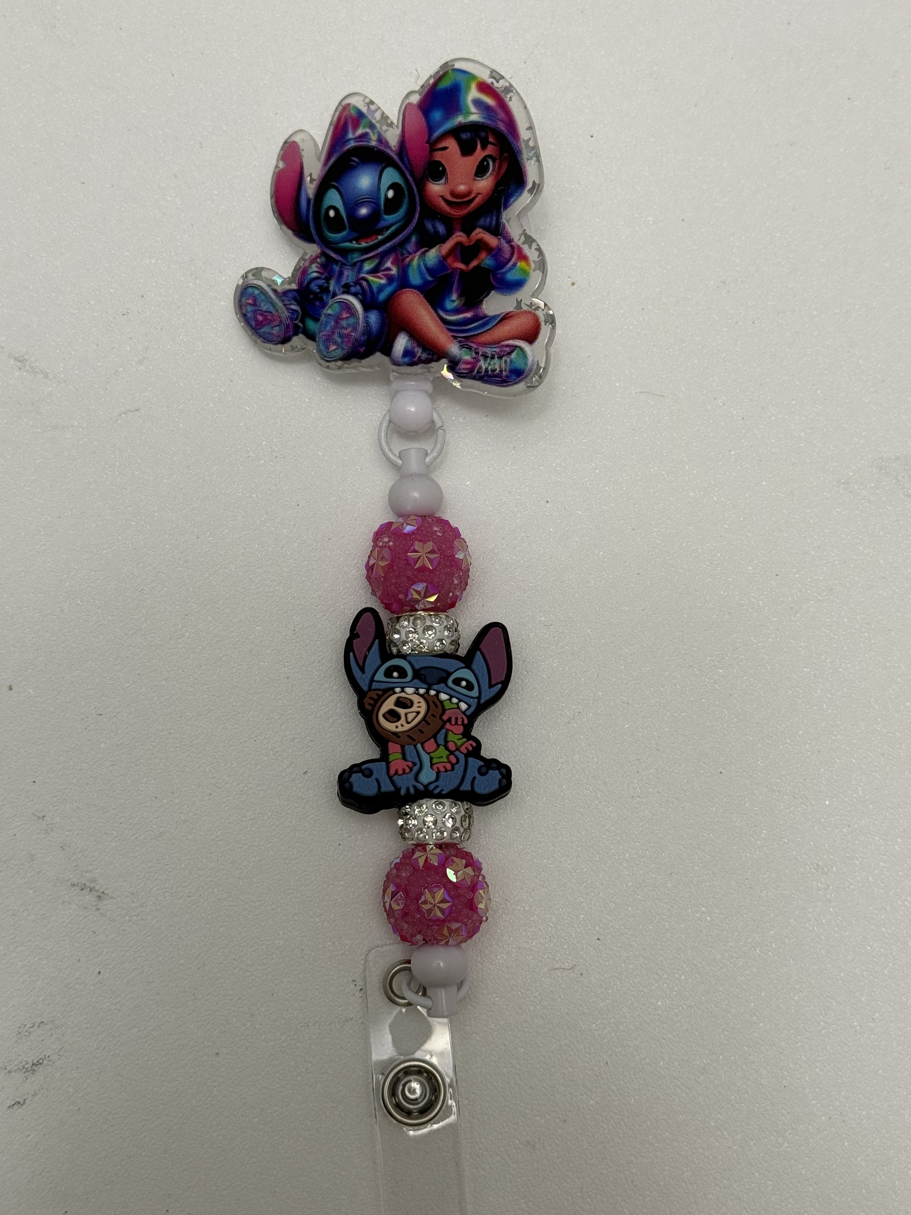 Beaded badge reel with tie-dye kawaii acrylic topper, pink rhinestone beads, and crystal spacers