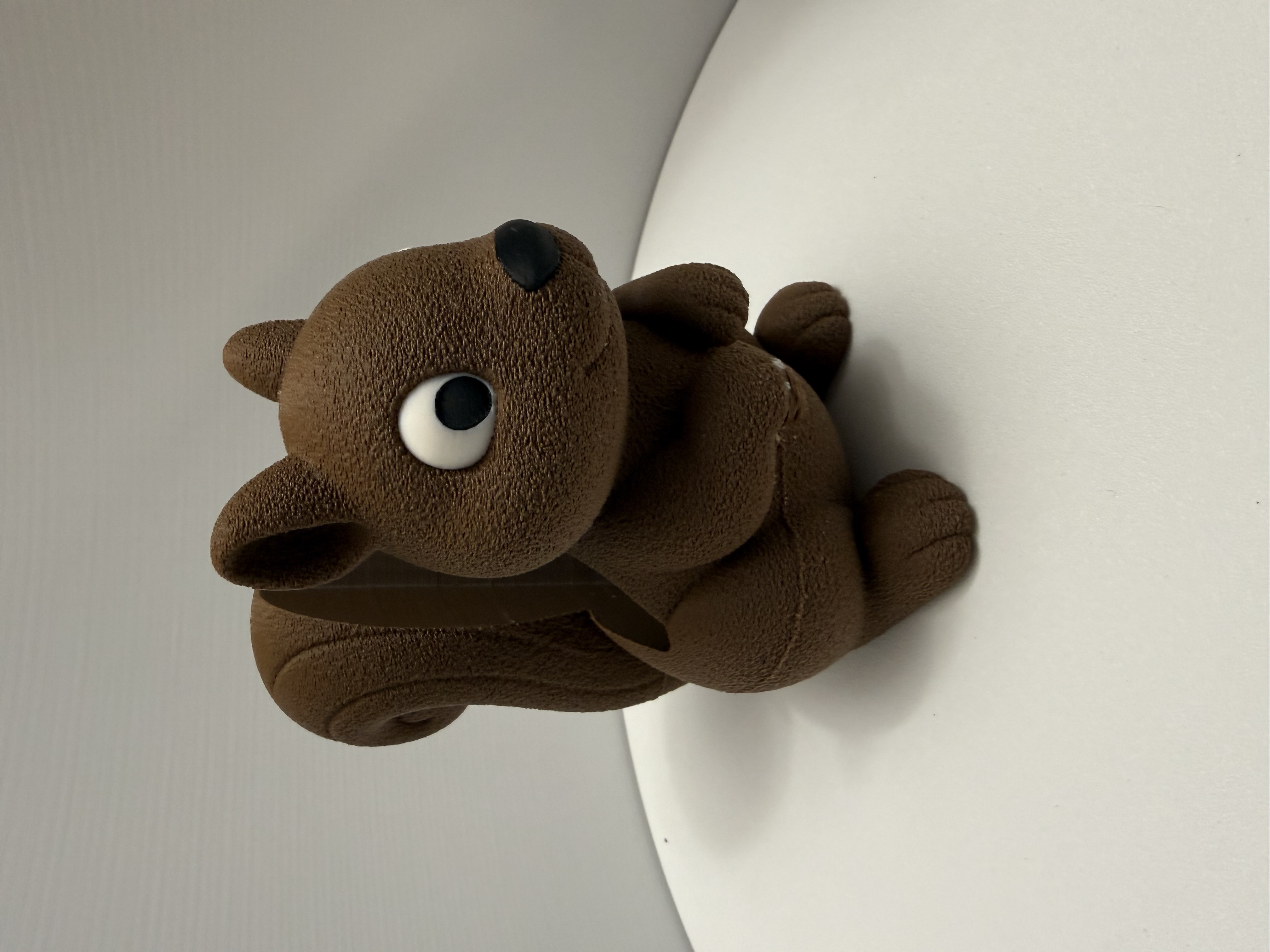 Brown textured cartoon squirrel soap dispenser holder with wide cartoon eyes and arched tail