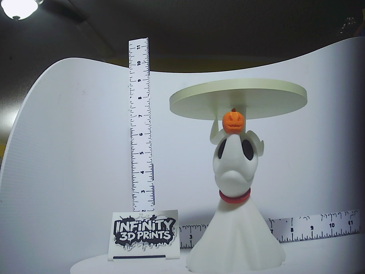 White ghost dog candle holder with orange jack-o-lantern head and wide flat disc top