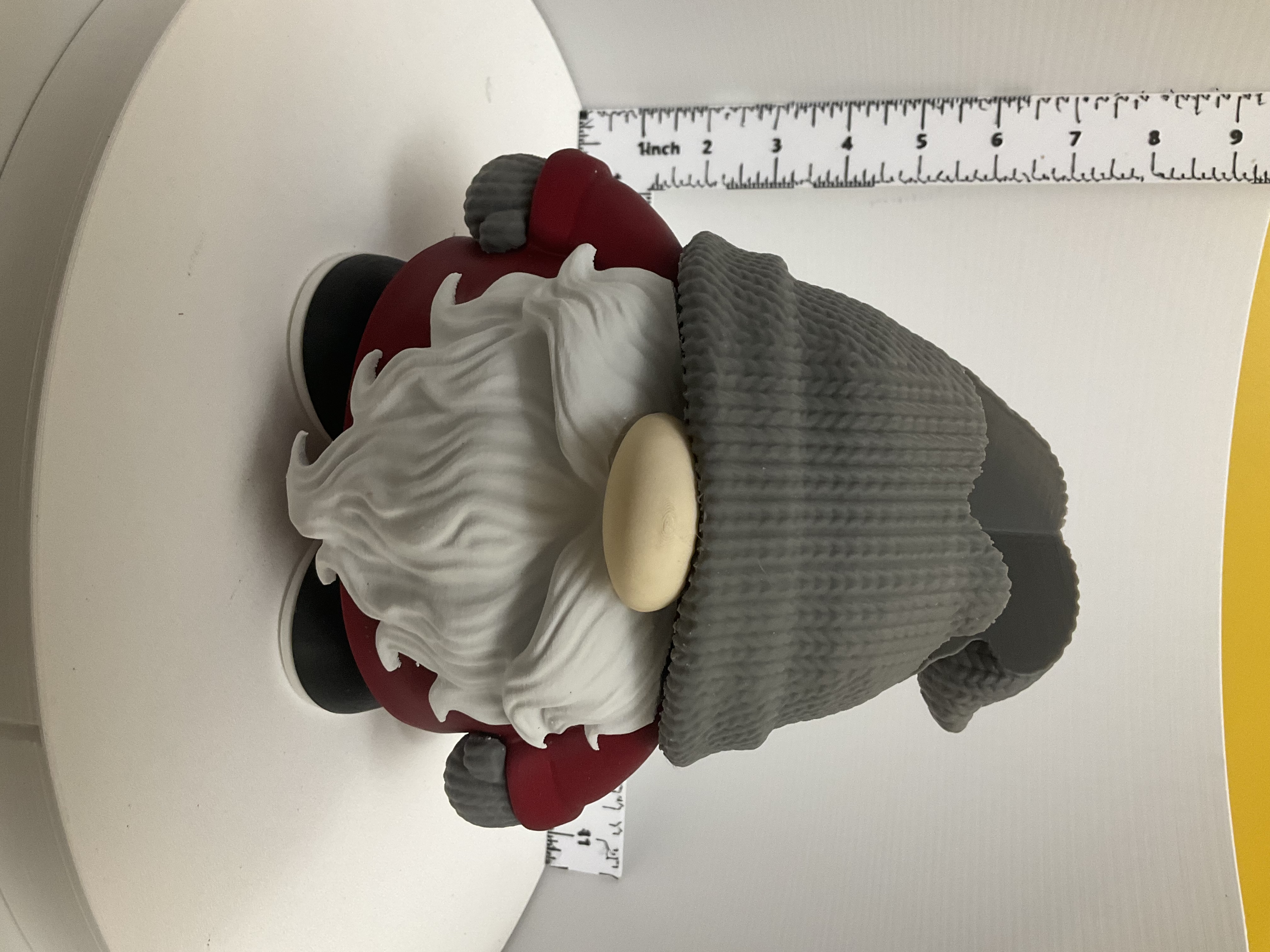 Front view of gnome soap dispenser holder with flowing white beard and red body