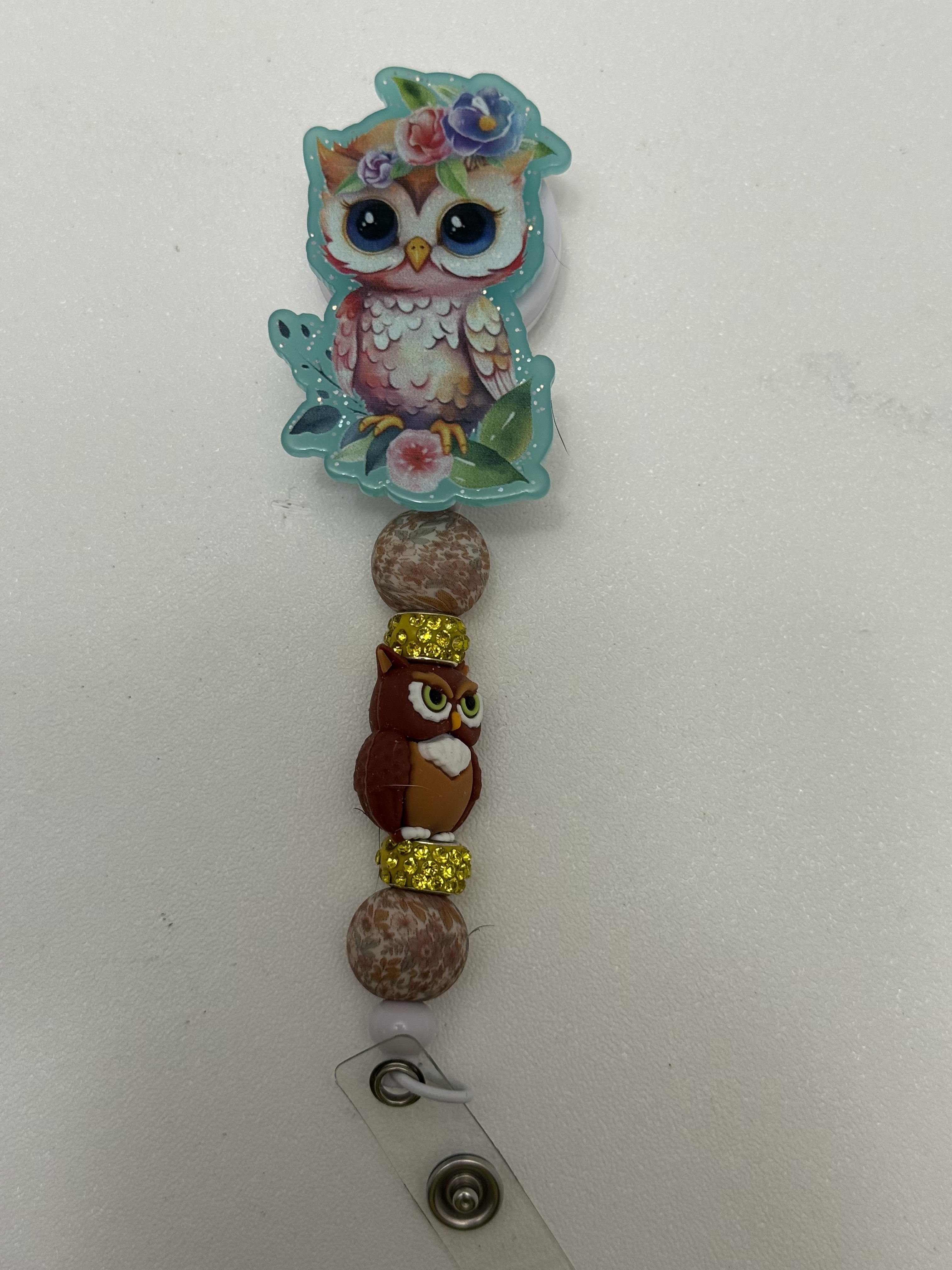 Retractable badge reel with floral owl topper, speckled beads, gold rhinestone rings, and brown owl focal bead