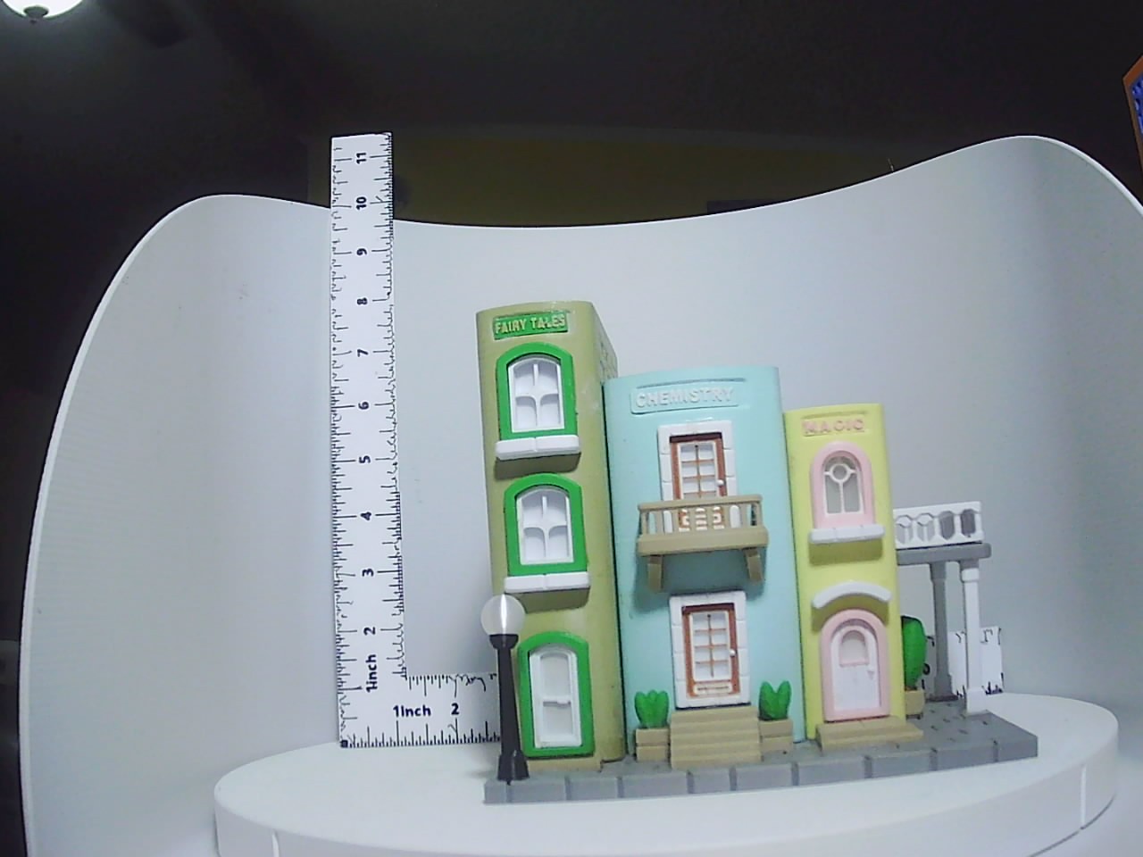 Full miniature village bookend set showing Fairy Tales Chemistry and Magic storefronts with street lamp