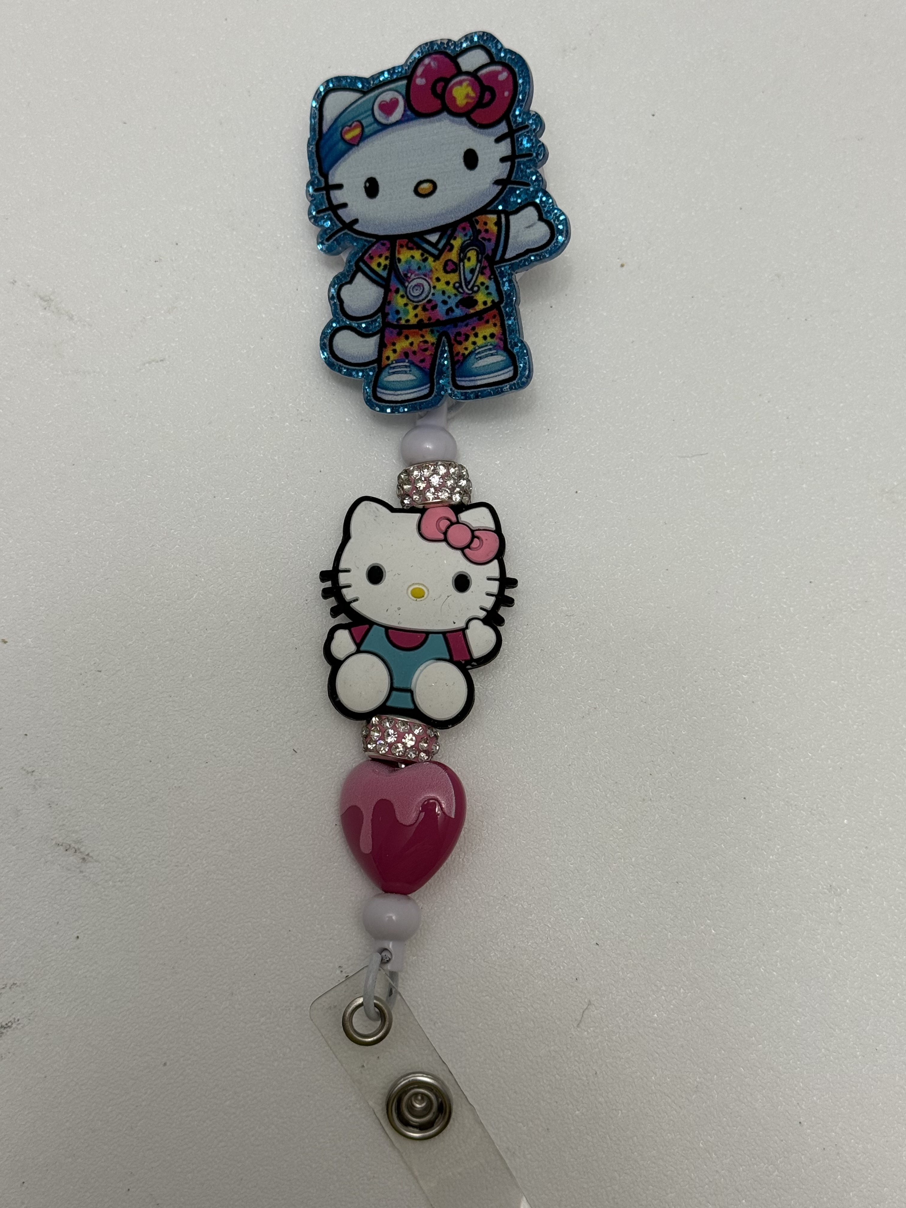 Retractable badge reel with glitter kawaii nurse cat topper, rhinestone spacers, enamel cat charm, and pink heart bead